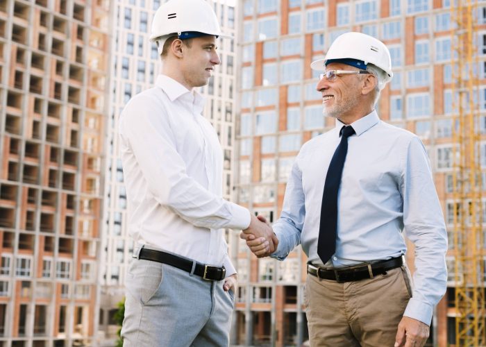 low-angle-businessmen-making-agreement-min